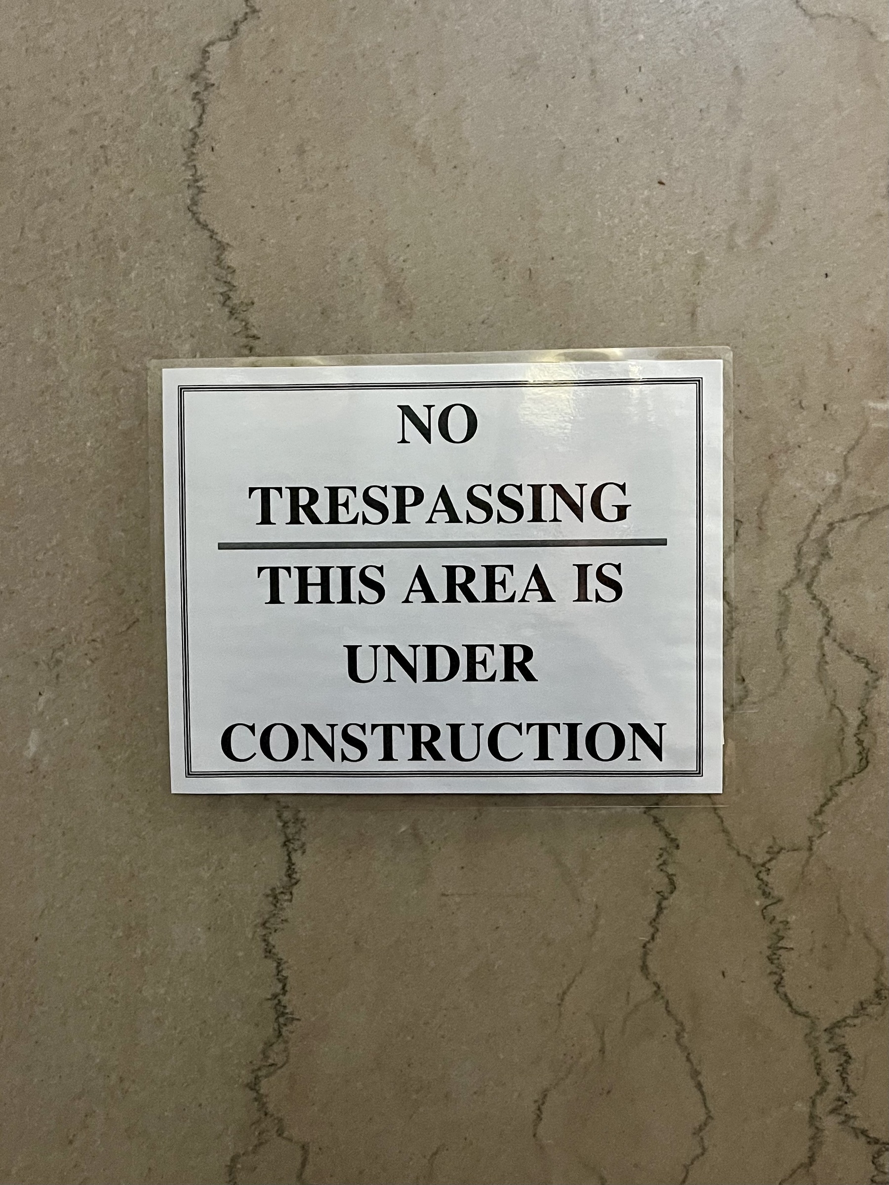 Sign on wall: “No trespassing. This area is under construction“